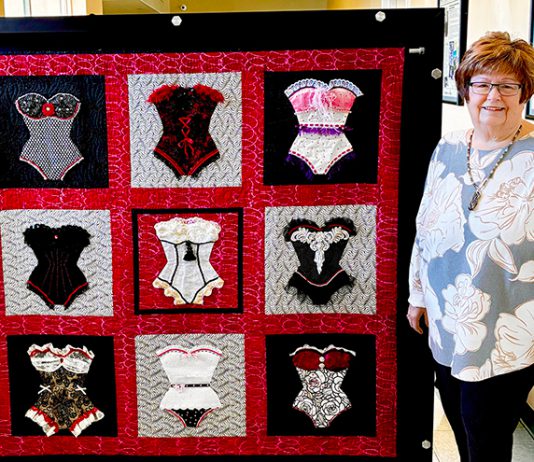 Quilt helps bring new mammography technology to Mee Memorial Hospital Woman stands by quilt