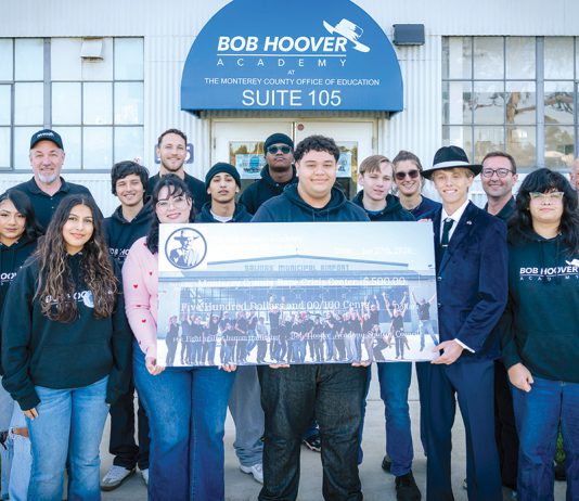Bob Hoover Academy students with check