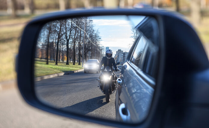 motorcycle and vehicle, view in a side mirror