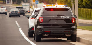 Behind view of a police car that pulled a motorist over to the side of the road