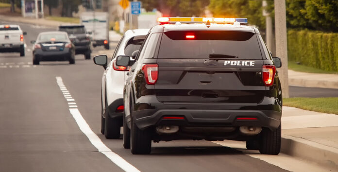 Behind view of a police car that pulled a motorist over to the side of the road