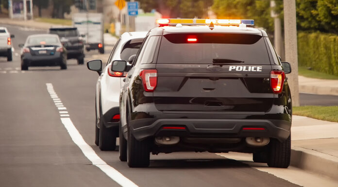 Behind view of a police car that pulled a motorist over to the side of the road