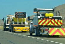Caltrans trucks mounted with Crash Cushions and flashing arrow lights protect highway-side workers