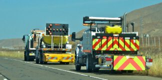 Caltrans trucks mounted with Crash Cushions and flashing arrow lights protect highway-side workers