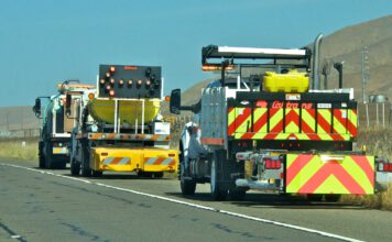 Caltrans trucks mounted with Crash Cushions and flashing arrow lights protect highway-side workers