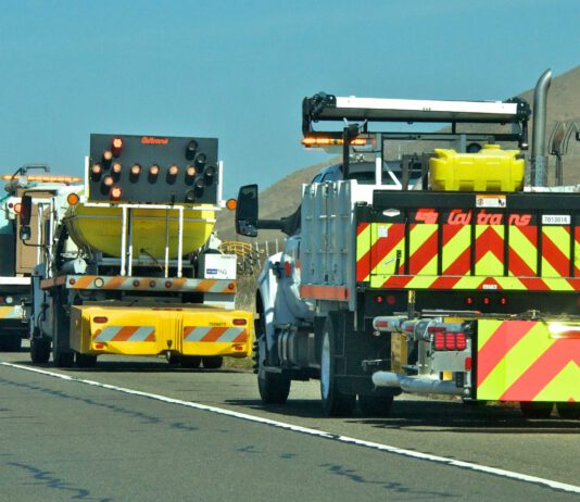 Caltrans trucks mounted with Crash Cushions and flashing arrow lights protect highway-side workers