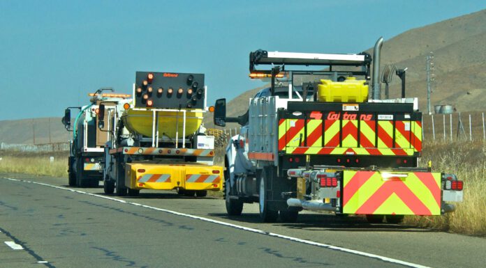 Brush clearing set for Highway 101 near San Ardo Caltrans trucks mounted with Crash Cushions and flashing arrow lights protect highway-side workers