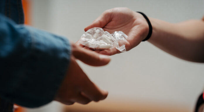 Drug youth school AdobeStock_1890479354 Drug dealing and drug buying at school