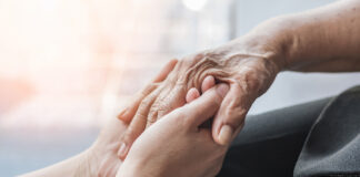 Parkinson disease patient, Alzheimer elderly senior, Arthritis person hand in support of nursing family caregiver care for disability awareness day