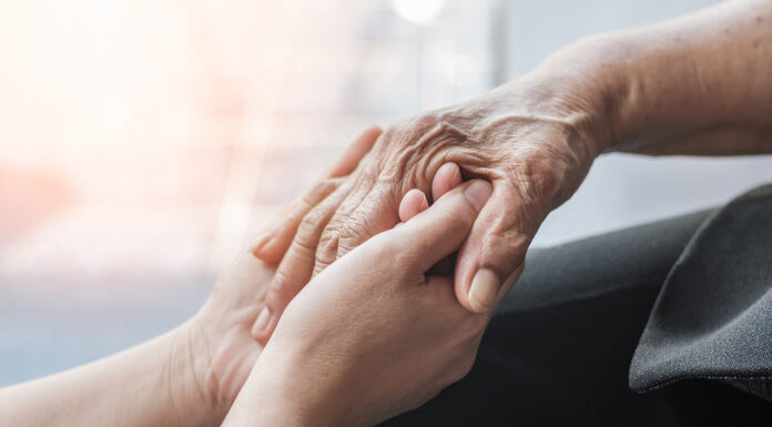 Alzheimer’s Association expands outreach in South Monterey County this fall Parkinson disease patient, Alzheimer elderly senior, Arthritis person hand in support of nursing family caregiver care for disability awareness day
